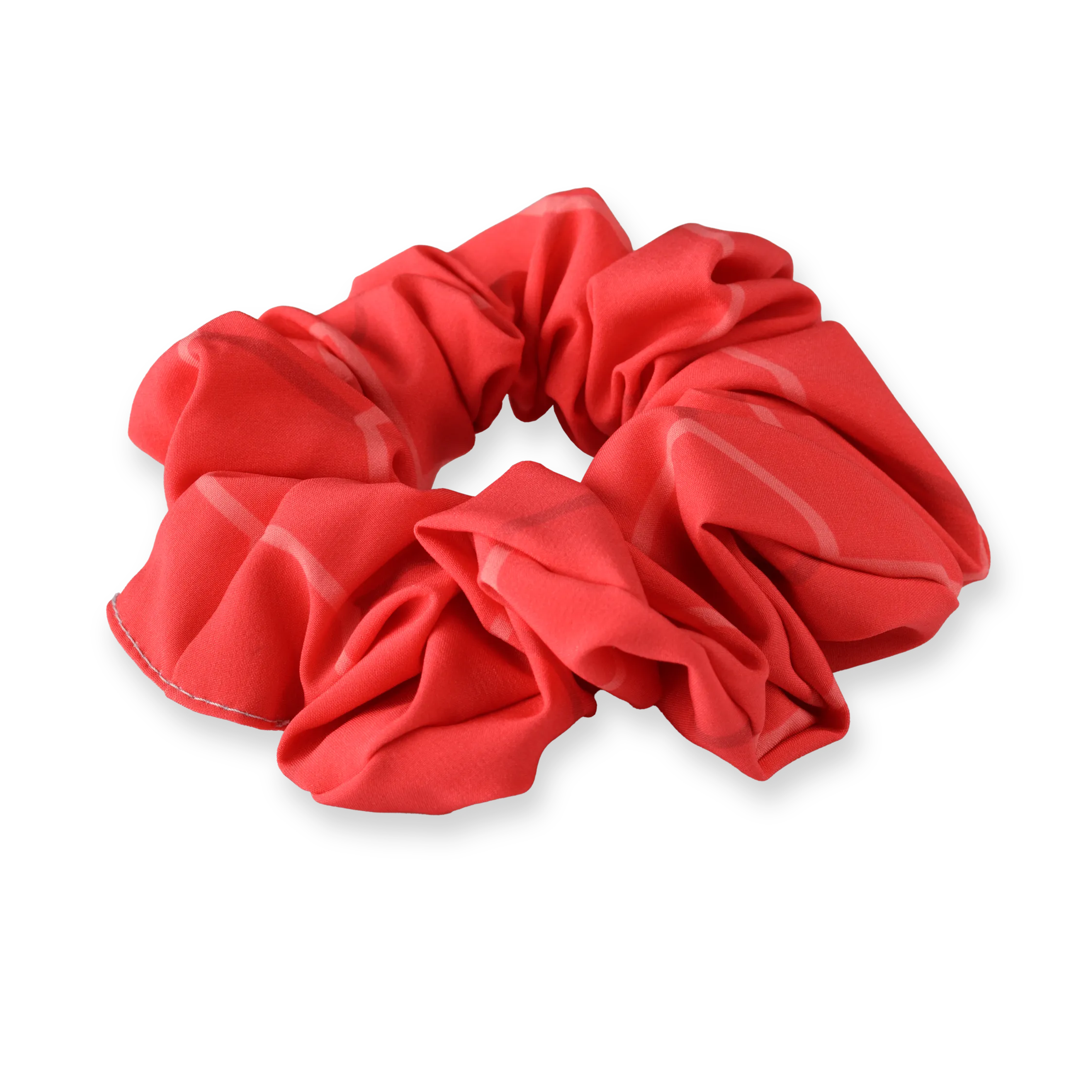 En rød scrunchie laget av mykt materiale med et avslappet design.